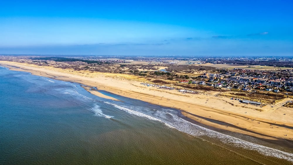 Drohnenaufnahme eines breiten Strandes an der niederländischen Küste