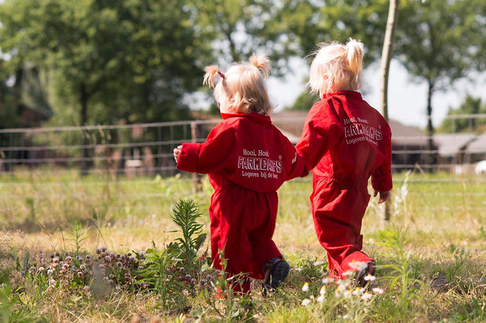 Young child walking across the farm during a farm holiday