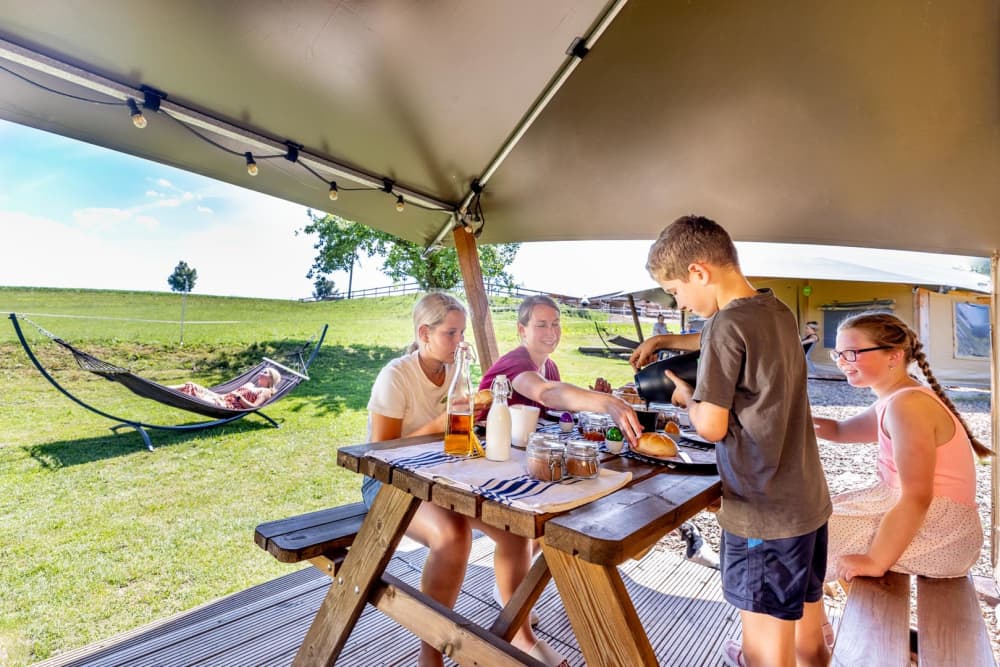 Family enjoying a farm holiday with a view of the fields